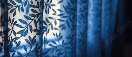 A detailed view of a blue and white cotton curtain, with intricate stitching and patterns visible up close. The fabric is illuminated by morning light, showcasing its texture and colors.