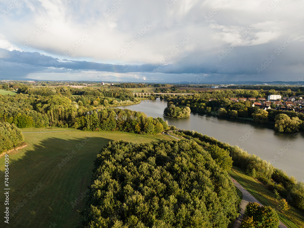 Obersee Bielefeld Aerial view of lake, meadows and forest in sunshine - drone shot north rhine westphalia