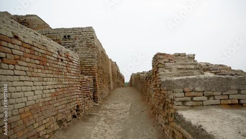an expansive archaeological site featuring the ruins of an ancient civilization. The remnants of brick structures stand testament to the complex architecture and urban planning of Mohenjo Daro.   