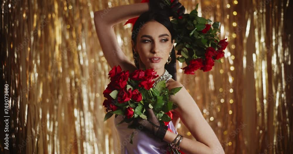 Beautiful trendy woman posing with bunch of red roses Beautiful trendy woman posing with bunch of red roses