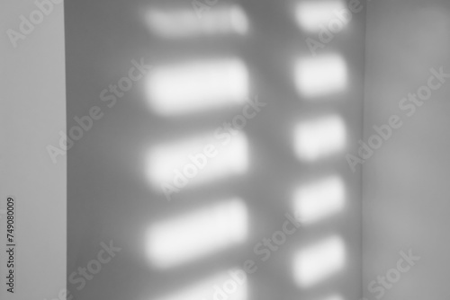 Light and shadows falling on white wall