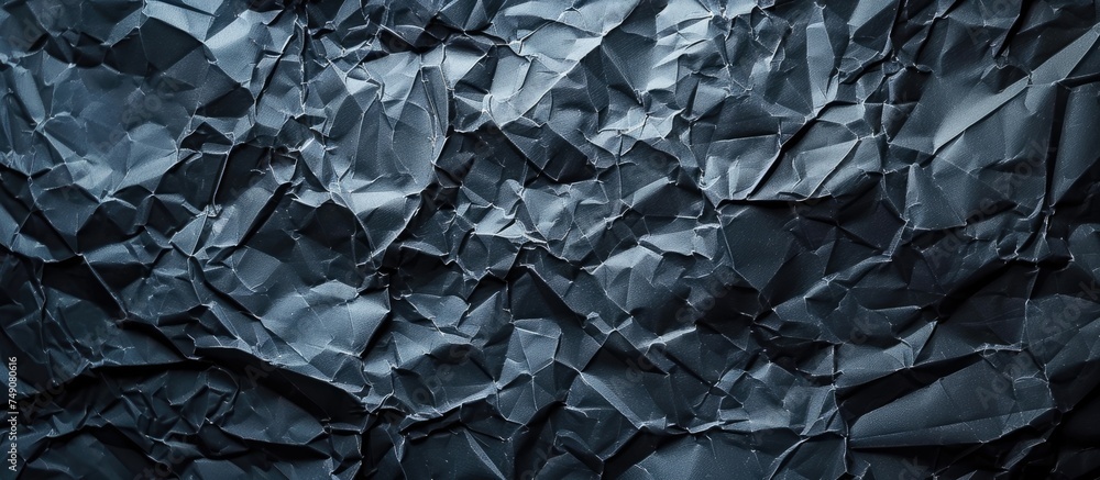 A black background is scattered with numerous small pieces of crumpled paper. The pieces vary in size and are randomly spread out, creating a textured and dynamic composition.