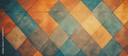 A painting featuring a striking diamond pattern in vibrant shades of orange, blue, and green on a color wooden parquet floor texture background. The colors create a bold and dynamic visual impact.