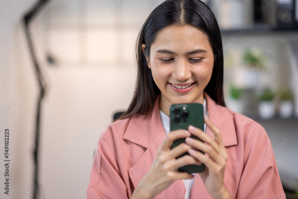Portrait of happy young asian woman accountant working documents on laptop and phone desk using calculator for calculate finance report in home office Portrait of happy young asian woman accountant working documents on laptop and phone desk using calculator for calculate finance report in home office