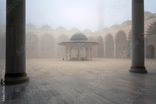 View of the courtyard and the place for ritual ablution of the Chamlyja Mosque on a foggy day, Istanbul, Turkey photo