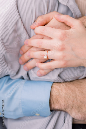  Couple in love are embracing with their hands together and hugging together.