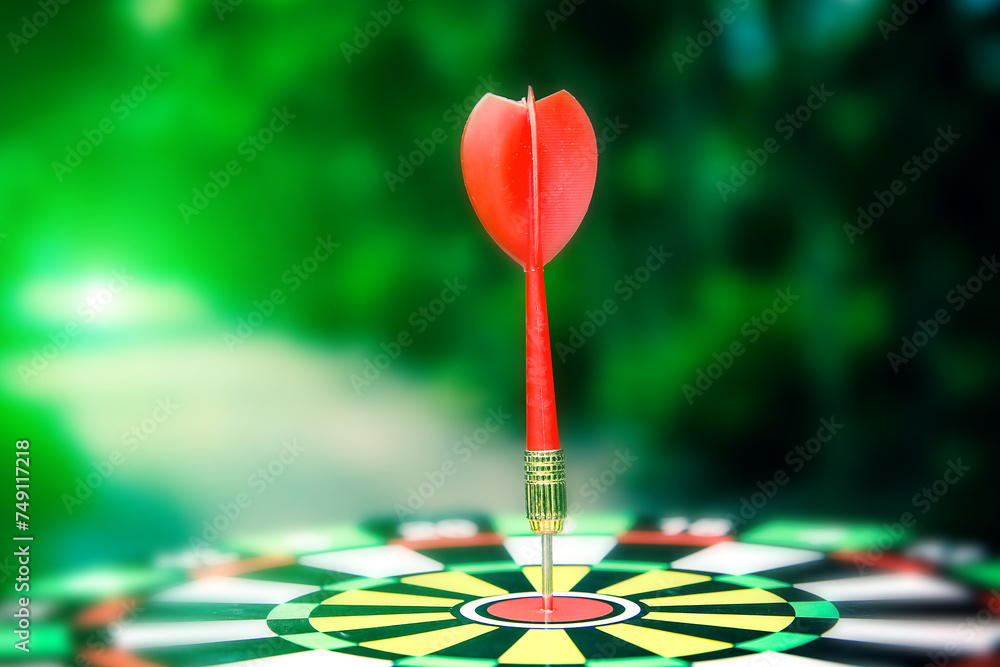 Bullseye or Bulls eye target or dartboard has red dart arrow throw hitting the center of a shooting for financial business targeting planning and aim to winner goal of business concept. Bullseye or Bulls eye target or dartboard has red dart arrow throw hitting the center of a shooting for financial business targeting planning and aim to winner goal of business concept.