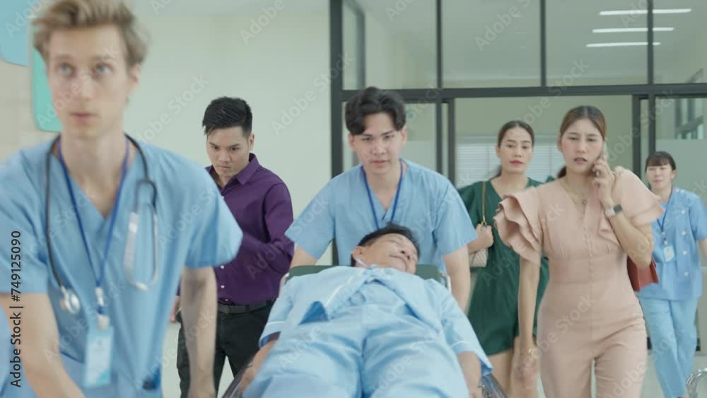 Emergency department : doctors, nurses and medical staff fush gurney - Stretcher and father, mother, son towards the operating room in modern hospital, doctor and with professional staff saving lives. Emergency department : doctors, nurses and medical staff fush gurney - Stretcher and father, mother, son towards the operating room in modern hospital, doctor and with professional staff saving lives.