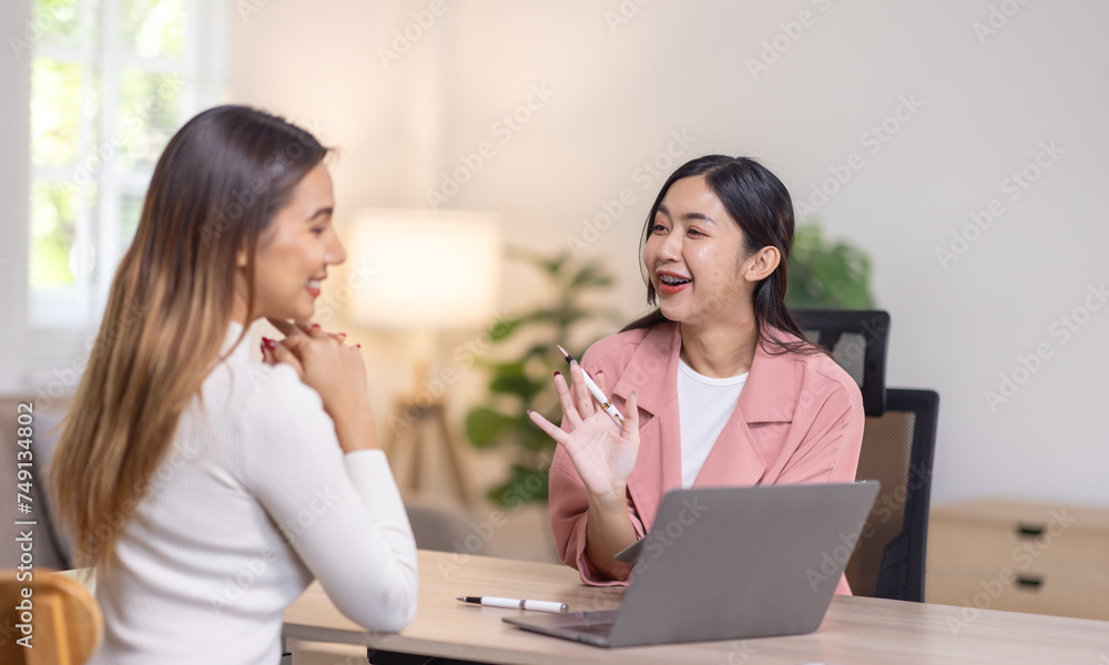 Two young asian happy business women working together for analyze planning and financial statistics and investment market in home office space Two young asian happy business women working together for analyze planning and financial statistics and investment market in home office space