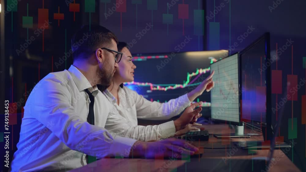 Side view of traders brokers in formalwear analyzing stock market data while working in the office Side view of traders brokers in formalwear analyzing stock market data while working in the office