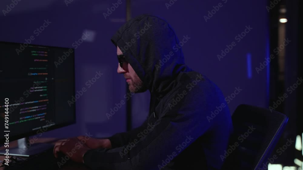 Hacker holding finger on lips. Programmer writes code for Hacker attack Hacker holding finger on lips. Programmer writes code for Hacker attack