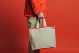 Man holding shopping bag on red background