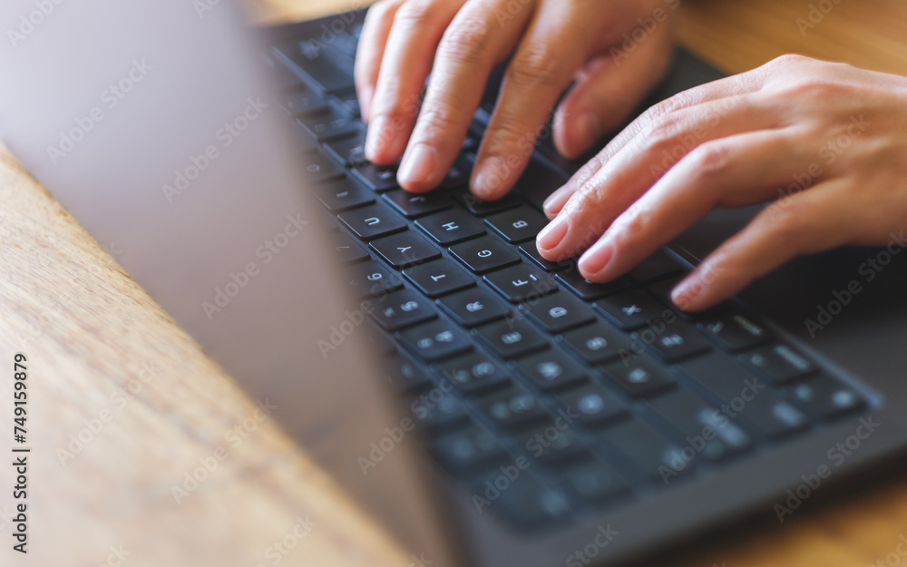 Closeup image of a woman working and typing on laptop computer keyboard Closeup image of a woman working and typing on laptop computer keyboard