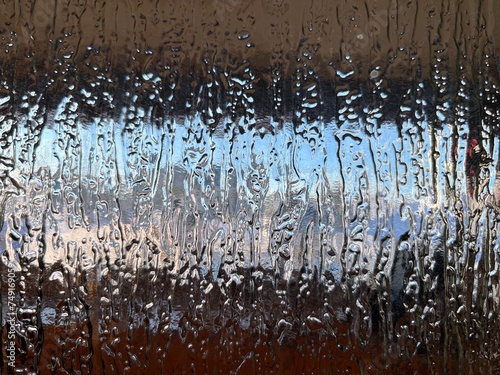 Abstract texture background of rinse water spraying on the windshield of a vehicle in an automated car wash