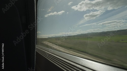 Looking out of window of high speed train going through spanish countryside photo