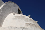 Greek traditional architectural detail, lime-washed walls against a blue sky