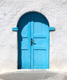 Greece: Blue door and lime-washed walls. Details of the beautiful traditional architecture.