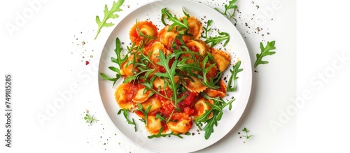 A white plate is filled with Italian ravioli covered in rich tomato sauce and garnished with fresh arugula leaves, creating a mouth-watering dish.