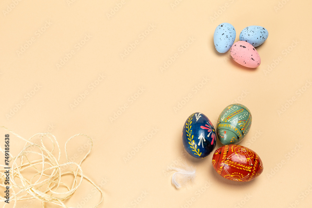 Easter eggs and a rope on the beige background.