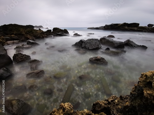 Coastal Serenity: Seaside Bliss with Beachside Rocks and Charming Homes in Nature's Embrace