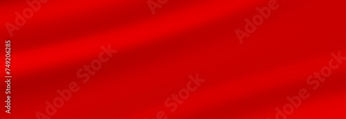 Abstract background, elegant red fabric or liquid waves or folds of satin silk background. Red silk cloth.