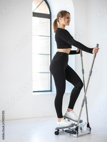Girl works out on a stepper