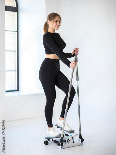 Girl works out on a stepper