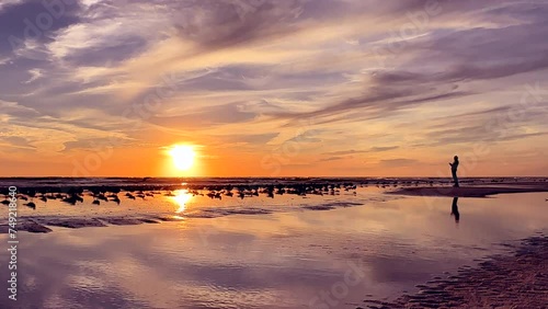 People enjoy tropical beach vacation during sunset