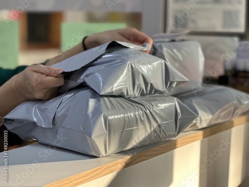 Packing a parcel for shipment. Poly Mailer Bag.