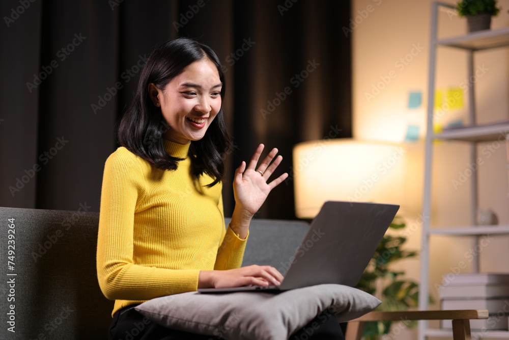 Woman sitting on sofa using laptop working at home. Woman sitting on sofa using laptop working at home.