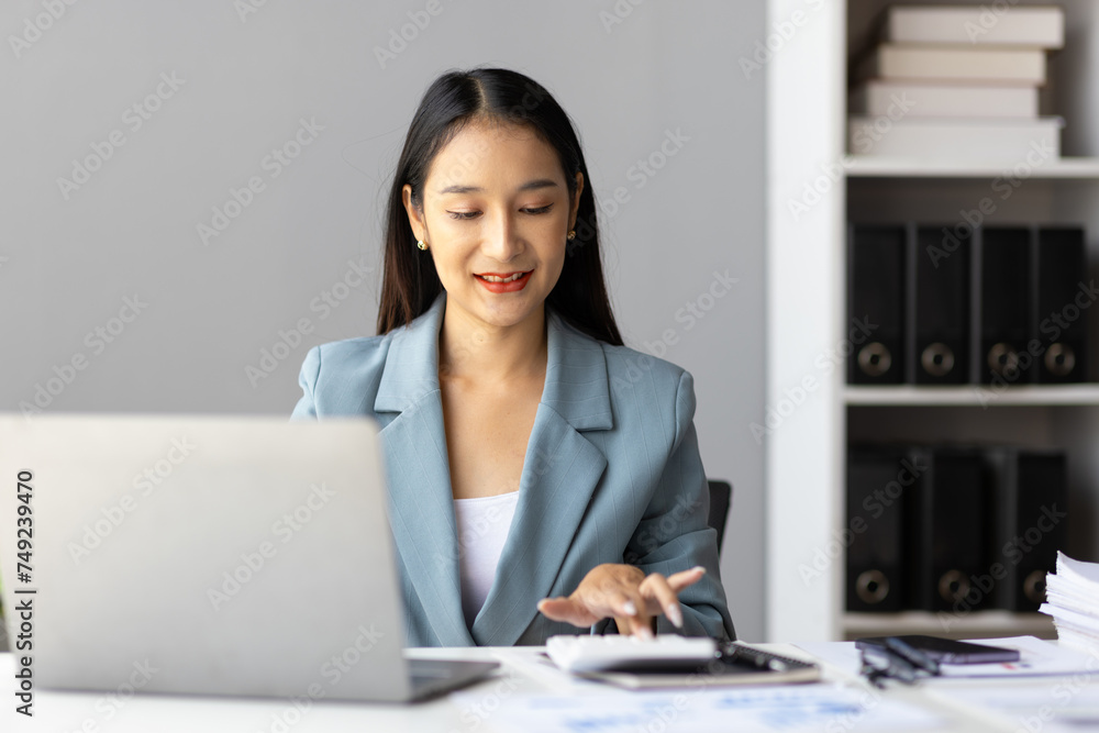 Asian businesswoman secretary doing paperwork on desk in office. Asian businesswoman secretary doing paperwork on desk in office.