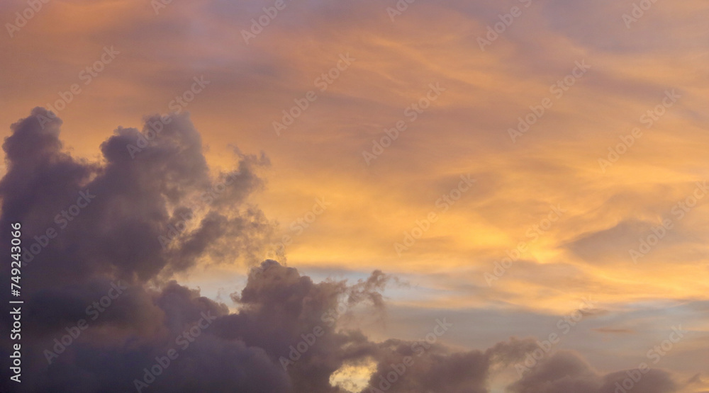 Orange sky at sunset. The clouds in the sky are colored orange by the rays of the setting sun. Clouds texture. Clouds at sunset background. Orange sky at sunset. The clouds in the sky are colored orange by the rays of the setting sun. Clouds texture. Clouds at sunset background.