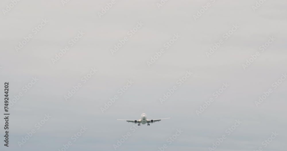 Low angle view of majestic airplane flying in cloudy sky. Modern air vehicle on journey. Concept of transportation. Low angle view of majestic airplane flying in cloudy sky. Modern air vehicle on journey. Concept of transportation.