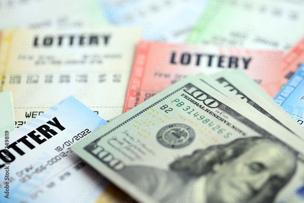 Many lottery tickets and dollar bills on blank bills with numbers for playing lottery close up Many lottery tickets and dollar bills on blank bills with numbers for playing lottery close up