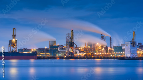 Heavy industry. View of production and factory. Panoramic view of the factory at night. Emission of harmful substances into the atmosphere. Photo for background, advertising and wallpaper.
