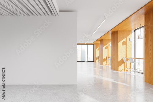 Wooden office interior with narrow tables and blank wall