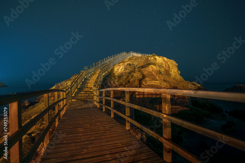 Mirador del Cabezo del Gavilán on the beaches of Puerto de Mazarrón, Region of Murcia, Spain, at night, with artificial lighting and starry sky photo