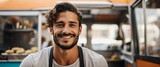 Small business owner young french man at front of food truck smiling looking at camera from Generative AI