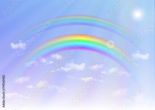 Rainbow on blue sky background 虹のかかった日が差し込む雨上がりの空