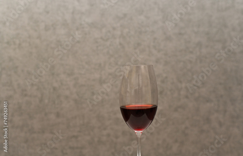 red wine in a glass. on a gray background