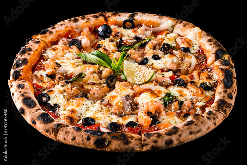 Italian food pizza with salmon, onion, olives, cheese, basil, tomato sauce, lime and spices isolated on black.