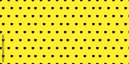 Seamless polka dot pattern: Vector illustration with small black freeform dots on a cheerful yellow backdrop. Creative texture of chaotic round and triangular shapes. Cute dotted wrapping paper sample