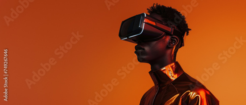 Person in stylish outfit sporting a virtual reality headset against a vibrant orange backdrop, merging technology and fashion