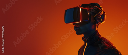 Front angled view capturing a figure standing still with a VR headset against an orange hue