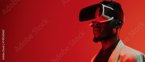 Sharp dressed man in a vivid red suit immersed in a virtual interface with VR technology
