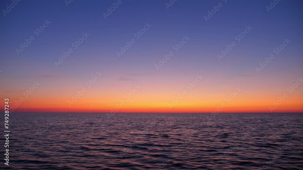 View from fast moving motorboat, water dash on foreground, vibrant colored sky on backdrop. Swift journey across Ladoga lake on summer evening. Sky in vibrant sunset afterglow hues View from fast moving motorboat, water dash on foreground, vibrant colored sky on backdrop. Swift journey across Ladoga lake on summer evening. Sky in vibrant sunset afterglow hues