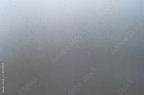 A window in small drops of water with a natural gradient of light. Background