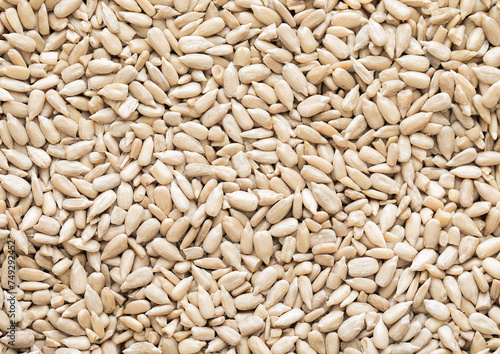 Healthy peeled sunflower seeds top view macro background.Healthy snack.