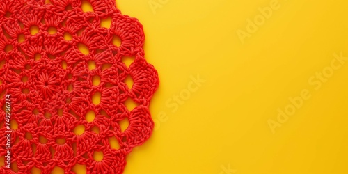 Red crochet doily on a yellow background with copy space.