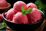 A beautifully presented strawberry ice cream on a rustic wooden table in a cozy cafe setting